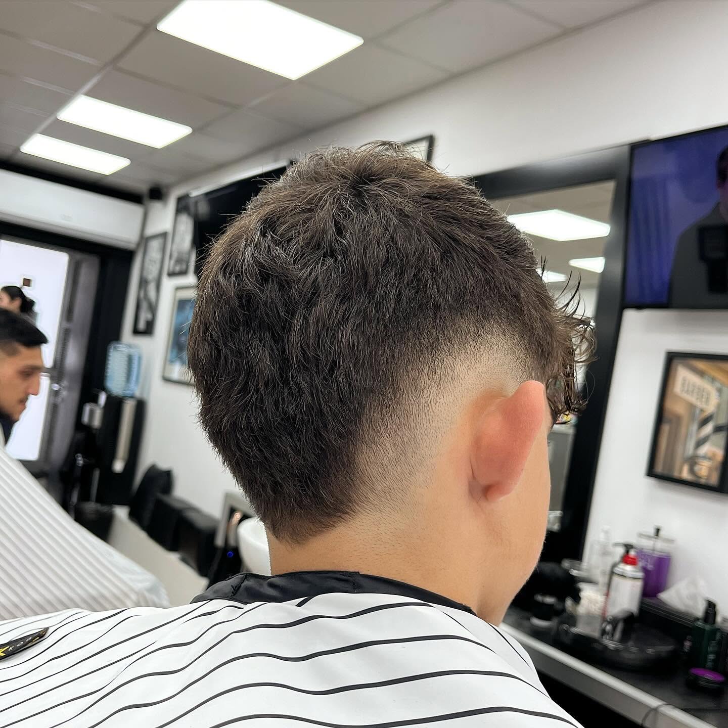 Curly haircut and fade viewed from the back at Andys Barbershop